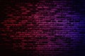 Neon light on brick walls that are not plastered background and texture. Lighting effect red and blue neon background vertical of Royalty Free Stock Photo