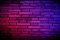 Neon light on brick walls that are not plastered background and texture. Lighting effect red and blue neon background vertical of Royalty Free Stock Photo