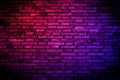 Neon light on brick walls that are not plastered background and texture. Lighting effect red and blue neon background vertical of Royalty Free Stock Photo
