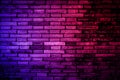 Neon light on brick walls that are not plastered background and texture. Lighting effect red and blue neon background vertical of Royalty Free Stock Photo