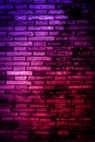 Neon light on brick walls that are not plastered background and texture. Lighting effect red and blue neon background vertical of Royalty Free Stock Photo