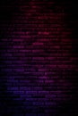Neon light on brick walls that are not plastered background and texture. Lighting effect red and blue neon background vertical of Royalty Free Stock Photo