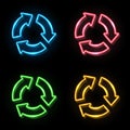 Blue red green yellow neon light color recycle symbol sign set on black background. 3 arrows in circle glowing icon. Royalty Free Stock Photo