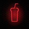 Neon light glow effect. Hot drink icon in glass with straw. Brick wall vector banner Royalty Free Stock Photo