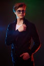 Neon light portrait of handsome male model with dark medium length hair, hairstyle, wear sunglasses Royalty Free Stock Photo