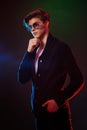 Neon light portrait of handsome male model with dark medium length hair, hairstyle, wear sunglasses Royalty Free Stock Photo