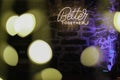 Neon light text Better together on a stone wall with bokeh lights effect