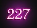 Pink glowing Neon light text effect of number 227. Royalty Free Stock Photo
