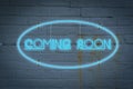 Neon lighton the wall with the word COMING SOON