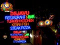 Neon restaurant street signs at night