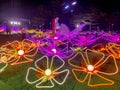 Neon lights in Tamar park glow colorfully at night in the shape of flowers and butterflies