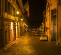 Neon lit cobblestone street, Rome, Italy Royalty Free Stock Photo
