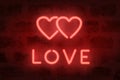 Neon love sign on the wall. Neon illuminated hearts