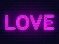 Neon love text on a brick wall. Valentines day background with purple glowing neon signboard with glowing backlight. Love