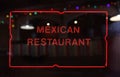 Neon Mexican Restaurant Sign in Rainy Window