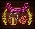 Neon Oktoberfest signs isolated on brick wall. Germany holiday light symbol, festival decoration effect. Neon oktoberfest