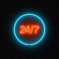 Neon open 24 hours in circle frame sign on a brick wall background. Royalty Free Stock Photo