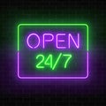 Neon open 24 hours 7 days a week sign in rectangle shape on a brick wall background. Royalty Free Stock Photo