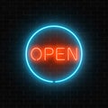 Neon open sign in a circle frame on a brick wall background. Round the clock working cocktail bar signboard Royalty Free Stock Photo