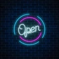 Neon open sign in circle shape on a brick wall background. Round the clock working bar or store signboard. Royalty Free Stock Photo