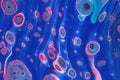 Neon pink cells swim though vibrant blue tubes in this abstract background. Royalty Free Stock Photo