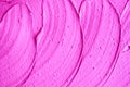 Neon pink face cream/mask/body wrap texture close up. Brush strokes. Abstract magenta background