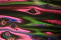 Neon pink and green wisps flow across deepest black in this abstract acrylic background.