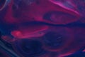 Neon pink, purple, and blue coalesce to create this dark abstract background.