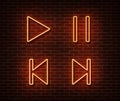 Neon player button signs vector isolated on brick wall. Play, pause, next, previous track light symb