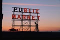 Neon public market sign at Pike Place Market and Elliott bay during the sunset Royalty Free Stock Photo