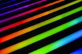 Neon rainbow strips on dark background. Soft focus Abstract rainbow color wave strips horizontal background. Royalty Free Stock Photo