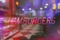 Neon Rainy Window Blur Image, Retro Diner With Hamburger Sign Royalty Free Stock Photo