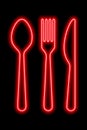 Neon red shapes of spoon, fork and table khife on a black background. Set of cutlery Royalty Free Stock Photo