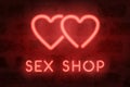 Neon sex shop vector sign. Red glowing hearts Royalty Free Stock Photo