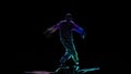 Neon shadow breakdancer man performs on black background. Computer processing