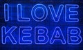 Neon shining sign in blue color on a brick wall with the inscription or slogan I love kebab. Brick wall, background. Bright Royalty Free Stock Photo