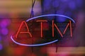 Neon Sign ATM in Bank Window With Bokeh