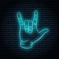 Neon sign with blue glow. Hand gesture, rock n roll.