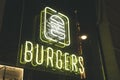 Neon sign burgers fast food city restaurant yellow color Royalty Free Stock Photo