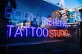Neon sign in central London with Body Piercing Tattoo