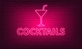 Neon sign Cocktails with glass on brick wall background. Vintage pink electric signboard with bright neon lights. Drink Night Club Royalty Free Stock Photo