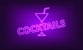 Neon sign Cocktails with glass on brick wall background. Vintage purple electric signboard with bright neon lights. Drink Night Royalty Free Stock Photo