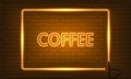 Neon sign COFFEE in a frame on brick wall background. Vintage electric signboard with bright neon lights. Orange light falls.