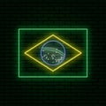 Neon sign in the form of the flag of Brazil. Against the background of a brick wall with a shadow.