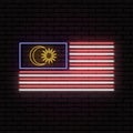 Neon sign in the form of the flag of Malaysia. Against the background of a brick wall with a shadow.