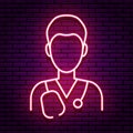 Neon sign in the form of an icon of a male doctor. Red colors on a brick wall background.