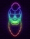 A neon sign in the form of a skull hipster with a beard, glasses and an iroquois.