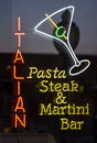 Neon sign glowing outside italian restaurant