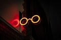 Neon Sign glowing red glasses shape on the street