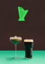 Neon sign of green harp above an Irish coffee with milk foam and pint of black stout craft beer Minimal pub concept. Plum